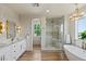 Elegant main bathroom with a soaking tub, walk-in shower, and a stylish double vanity at 11550 Lampeter Ct, Las Vegas, NV 89138
