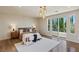 Spacious main bedroom featuring a large window, comfortable seating, and elegant hardwood floors at 11550 Lampeter Ct, Las Vegas, NV 89138