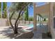 Resort-style pool and spa surrounded by lush landscaping, patio, and covered outdoor space at 11550 Lampeter Ct, Las Vegas, NV 89138