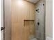 Modern shower featuring unique wood and gray tile work, glass doors, and built in niche at 11550 Lampeter Ct, Las Vegas, NV 89138