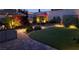 Backyard patio and lawn is well-lit and inviting for enjoying evening outdoor space at 12286 Silvana St, Las Vegas, NV 89141
