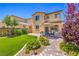Beautiful backyard with stone patio, landscaped yard, and comfortable outdoor seating beneath a shady umbrella at 12286 Silvana St, Las Vegas, NV 89141
