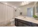 A bathroom with a shower and tub, decorative mirror and under sink cabinet at 12286 Silvana St, Las Vegas, NV 89141