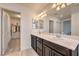 Spacious bathroom featuring dual sinks, large mirrors and a walk-in closet at 12286 Silvana St, Las Vegas, NV 89141
