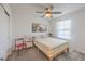 A bright bedroom with a simple bed frame, colorful linens and natural light at 12286 Silvana St, Las Vegas, NV 89141