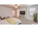 Bright bedroom with a bed, a desk, a ceiling fan and an ensuite bathroom at 12286 Silvana St, Las Vegas, NV 89141