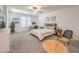 Neutral bedroom with a ceiling fan, carpet, a large window and desk area at 12286 Silvana St, Las Vegas, NV 89141