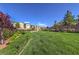 Community green space boasts lush lawn, landscaped flowerbeds and bushes with manicured lawns at 12286 Silvana St, Las Vegas, NV 89141