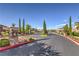 Community entrance with stone pillars, wrought iron gates, and well-maintained landscaping at 12286 Silvana St, Las Vegas, NV 89141
