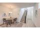 Inviting dining area with a stairway, offering a seamless transition to the upper level of the home at 12286 Silvana St, Las Vegas, NV 89141