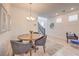 Dining area with a round wooden table, comfortable seating, and a stylish chandelier for elegant dining at 12286 Silvana St, Las Vegas, NV 89141