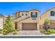 Charming two-story home showcasing a well-manicured front yard and a two-car garage for convenient parking at 12286 Silvana St, Las Vegas, NV 89141