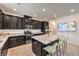Beautiful kitchen with granite counters, an island, and dark wood cabinets at 12286 Silvana St, Las Vegas, NV 89141