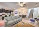 Open-concept living room with a modern kitchen and dining area, creating a seamless and inviting space at 12286 Silvana St, Las Vegas, NV 89141