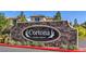 Stone community sign 'Cortona at Southern Highlands' surrounded by green bushes and manicured landscaping at 12286 Silvana St, Las Vegas, NV 89141