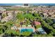 Aerial view of a residential community with pools, parks, green spaces, and city views at 1560 Plaza Centre Dr # 103, Las Vegas, NV 89135
