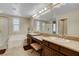 Bright bathroom featuring double sinks, a soaking tub with tile surround, and a shower at 1560 Plaza Centre Dr # 103, Las Vegas, NV 89135