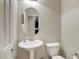 Bathroom features a pedestal sink and toilet with a door nearby at 1560 Plaza Centre Dr # 103, Las Vegas, NV 89135