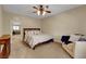 This bedroom is well lit with a ceiling fan, window, and a view into the loft at 1560 Plaza Centre Dr # 103, Las Vegas, NV 89135
