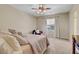 Bedroom featuring a plush carpet, ceiling fan, large window, and an additional seat for relaxing at 1560 Plaza Centre Dr # 103, Las Vegas, NV 89135