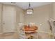 Well-lit dining area featuring a round wooden table and comfortable seating at 1560 Plaza Centre Dr # 103, Las Vegas, NV 89135