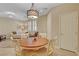 Inviting dining space with a wooden table and white chairs near the living area at 1560 Plaza Centre Dr # 103, Las Vegas, NV 89135