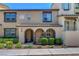 Charming townhome facade with arched entryway and well-maintained landscaping at 1560 Plaza Centre Dr # 103, Las Vegas, NV 89135