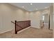 Upstairs landing with wood banister and neutral carpeting at 1560 Plaza Centre Dr # 103, Las Vegas, NV 89135