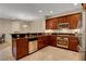 Kitchen features stainless steel appliances, dark wood cabinets and tile floor at 1560 Plaza Centre Dr # 103, Las Vegas, NV 89135
