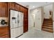 Kitchen has stainless steel refrigerator and dark wood cabinets with tile floor at 1560 Plaza Centre Dr # 103, Las Vegas, NV 89135