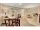 Bright living room with neutral walls, plush sofa, and unique accent chairs at 1560 Plaza Centre Dr # 103, Las Vegas, NV 89135