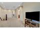 Open loft with neutral carpet, paint, recessed lights, and a view of the hallway at 1560 Plaza Centre Dr # 103, Las Vegas, NV 89135