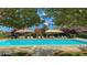 Community pool surrounded by lounge chairs and shady umbrellas at 1560 Plaza Centre Dr # 103, Las Vegas, NV 89135