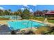 Community pool with clear blue water, surrounded by a deck, chairs, and lush greenery at 1560 Plaza Centre Dr # 103, Las Vegas, NV 89135