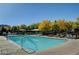 Community pool featuring clear blue water surrounded by a deck and comfortable lounge chairs at 1560 Plaza Centre Dr # 103, Las Vegas, NV 89135