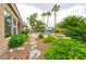 Landscaped backyard featuring a stone path, lush greenery, and a pool, creating a serene and inviting outdoor space at 1704 River Birch St, Las Vegas, NV 89117