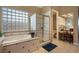 This bathroom has a glass block window next to the soaking tub and a separate vanity at 1704 River Birch St, Las Vegas, NV 89117