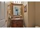 Charming half-bathroom with a granite countertop vanity and decorative mirror at 1704 River Birch St, Las Vegas, NV 89117