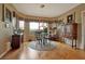 Elegant dining room with large windows, hardwood floors, and stylish furnishings at 1704 River Birch St, Las Vegas, NV 89117