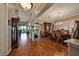 Spacious dining room with hardwood floors, a chandelier, and an open layout to the living room and kitchen area at 1704 River Birch St, Las Vegas, NV 89117
