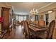 Formal dining room with hardwood floors, a large dining table, and a view to the fireplace with a living room beyond at 1704 River Birch St, Las Vegas, NV 89117