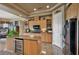 Modern kitchen featuring granite countertops, a wine fridge, custom cabinets, and modern appliances at 1704 River Birch St, Las Vegas, NV 89117