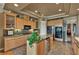 Well-lit kitchen featuring an island with a wine cooler and granite countertops with stone floors at 1704 River Birch St, Las Vegas, NV 89117