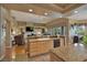 Open-concept kitchen and living area featuring granite countertops, hardwood floors and large windows at 1704 River Birch St, Las Vegas, NV 89117
