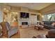 Living room with fireplace, built-in shelving, and a view to the backyard at 1704 River Birch St, Las Vegas, NV 89117