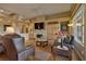 Comfortable living room with hardwood floors, fireplace, and lots of natural light at 1704 River Birch St, Las Vegas, NV 89117