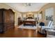 Spacious main bedroom with hardwood floors, elegant furniture, and ample natural light at 1704 River Birch St, Las Vegas, NV 89117