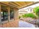 Outdoor patio with stone tiles, lush landscaping, and a view of the surrounding neighborhood at 1704 River Birch St, Las Vegas, NV 89117