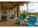 Outdoor patio with comfortable seating, palm trees, and a pool view at 1704 River Birch St, Las Vegas, NV 89117