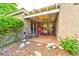 Charming outdoor patio with a covered area, stone accents, and garden space at 1704 River Birch St, Las Vegas, NV 89117
